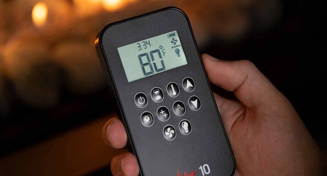 The fireplace remote, showing the temperature display and the button cluster.