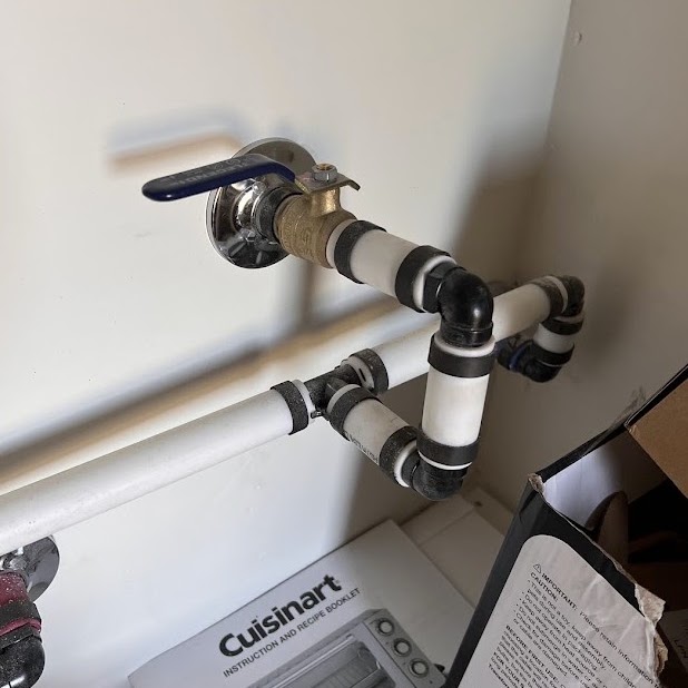 The interior ball valve in the laundry room with the handle across the pipe, closed.